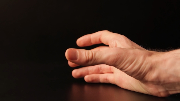 Glass of Alcohol Sliding Across the Bar Counter Hand Picks Up a Drink on Black Background