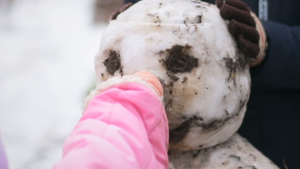 Little Girl Without Gloves Inserts Carrot Snowman Instead Nose
