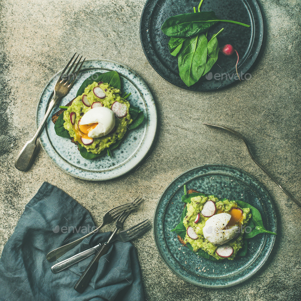 Healthy vegetarian wholegrain avocado toasts with poached egg, square crop - Stock Photo - Images