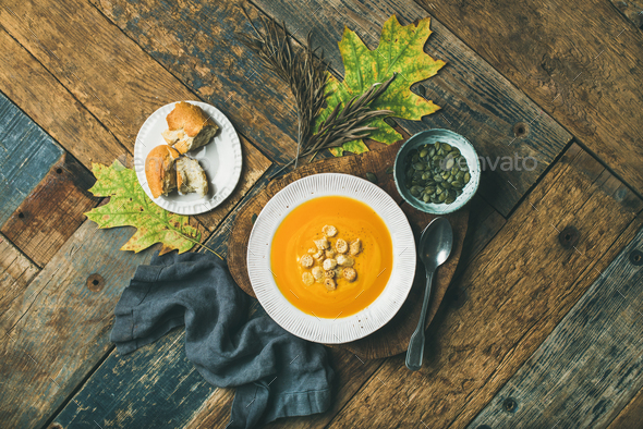 Warming pumpkin cream soup with croutons and seeds, top view - Stock Photo - Images