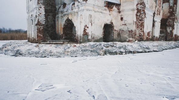 Abandoned Cathedral Building in Middle of Frozen Lake Covered in Snow