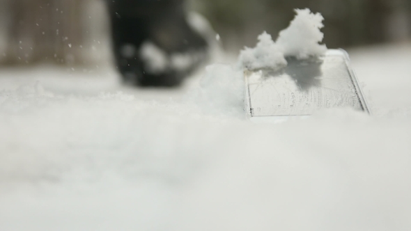 Human Walks Past Lost Phone in Snow