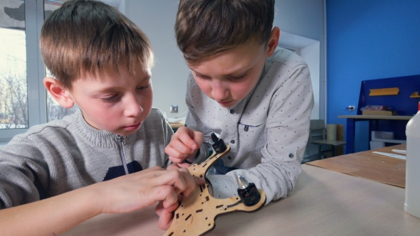 Two Boys Are Finishing Their Wooden Drone Model alt
