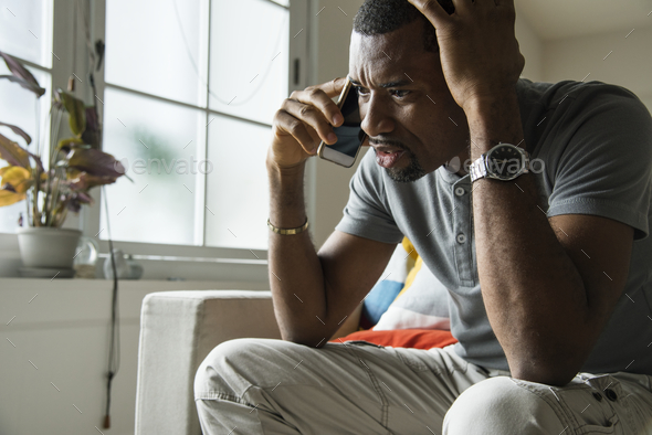 Black guy talking phone with angry emotion - Stock Photo - Images
