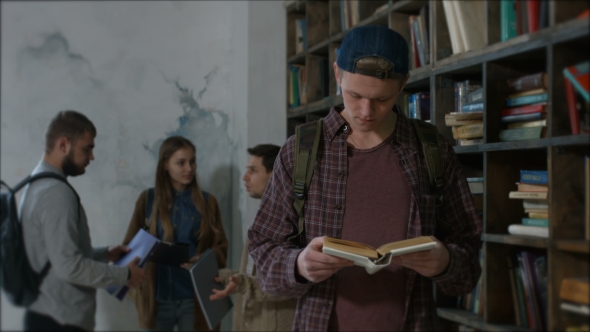 Handsome High School Student Studying in Library alt