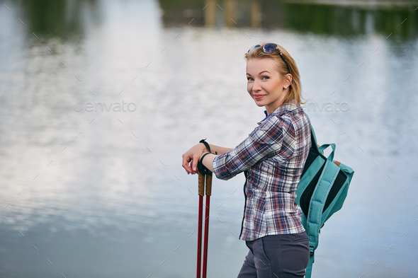 young woman with nordic walk pols
