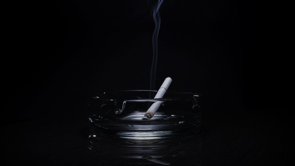 Ashtray with cigarette rotates