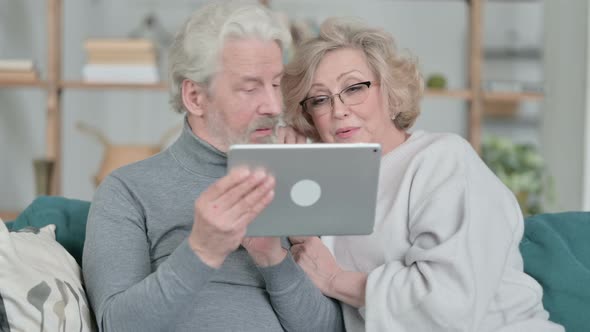 Online Video Call on Tablet By Old Couple at Home alt