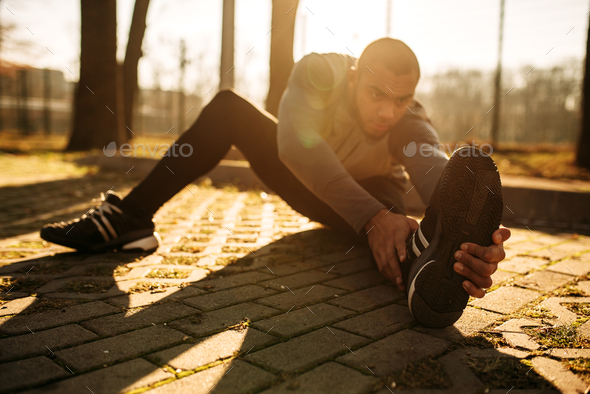 Male sportsman warming up before run - Stock Photo - Images