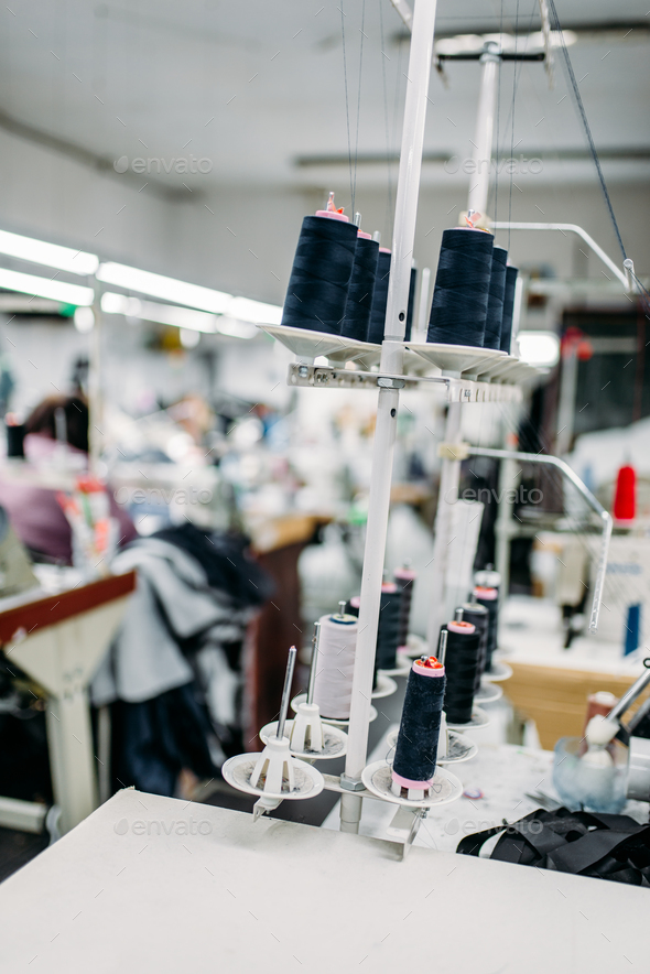 Black threads on spools closeup, overlock machine - Stock Photo - Images