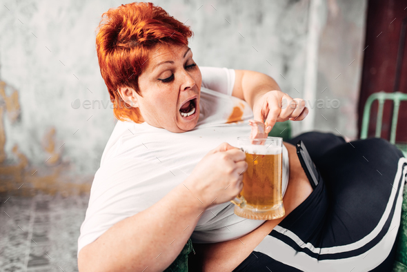 Overweight woman drinks beer, obesity - Stock Photo - Images