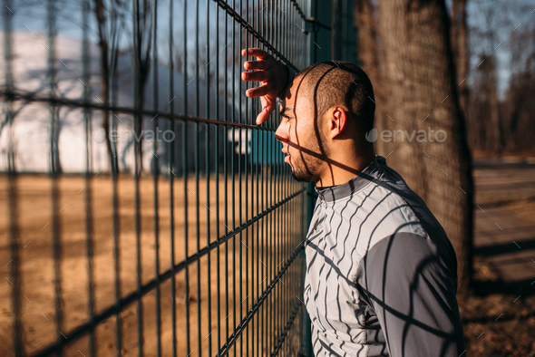 Tired male jogger after fitness workout in park - Stock Photo - Images