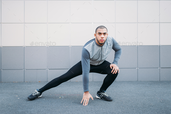 Athlete doing stretching exercise before running - Stock Photo - Images