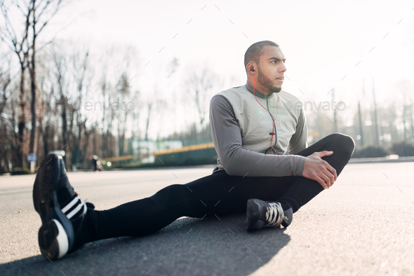 Athlete doing stretching exercise before running - Stock Photo - Images