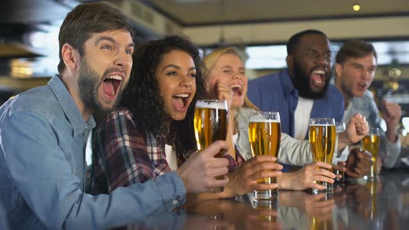 Emotional Sport Fans Clinking Beer Glasses, Celebrating Team Victory in Pub alt
