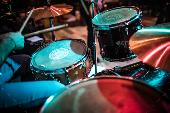 Drummer playing on drum set on stage. - Stock Photo - Images