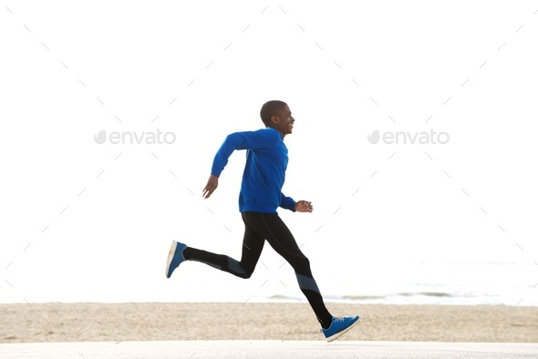 Young African-American black man jogging and running on a path and