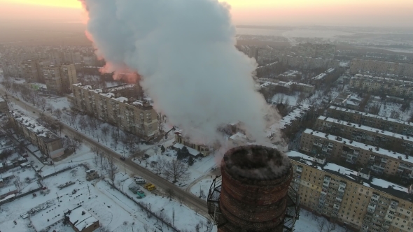 Aerial  Shot of a High Industrial Pipe with White Smog at Sunset in Winter