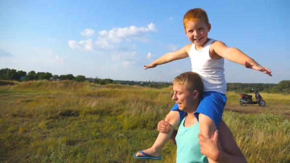 Happy Father and Son Playing on the Field at Sunny Summer Day alt