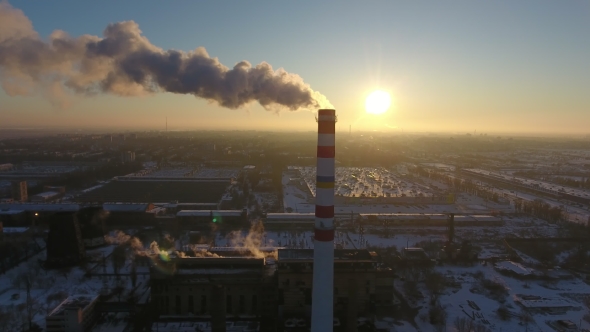Aerial Shot of a White and Red Cooling Tower with White Smoke at Sunset in Winter