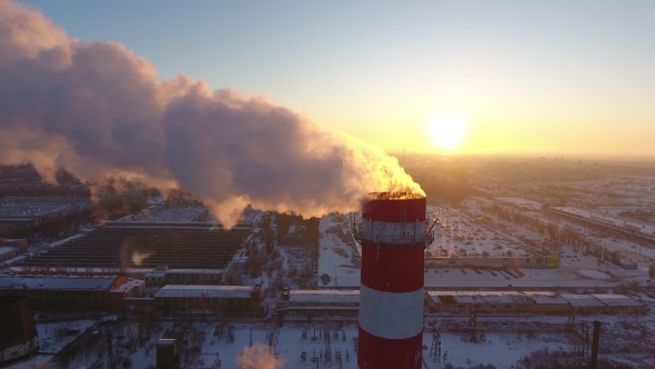Aerial  of a Sky-high Cooling Tower with White Smoke at Sunset in Winter