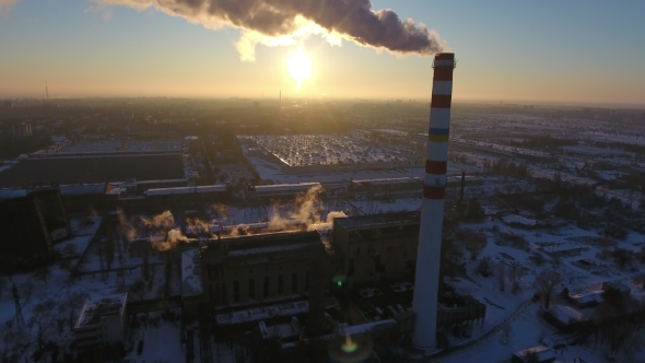 Aerial Shot of a White and Red Hot Gas Chimney with White Smoke at Sunset in Winter
