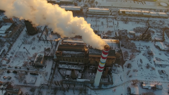 High Hot Gas Tower with White Smoke at Sunset in Winter