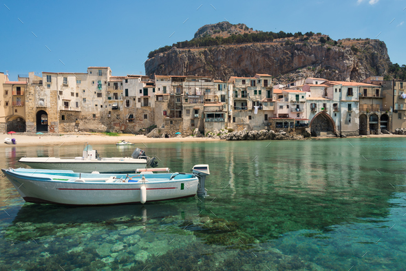 Boats and clear water in Cefalu town - Stock Photo - Images