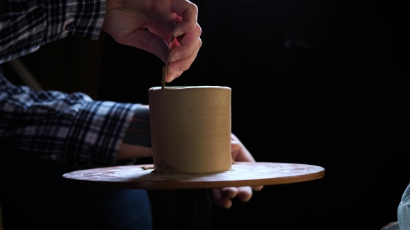 of Hands Working Clay on Potter's Wheel. Potter Shapes the Clay Product with Pottery Tools on the alt