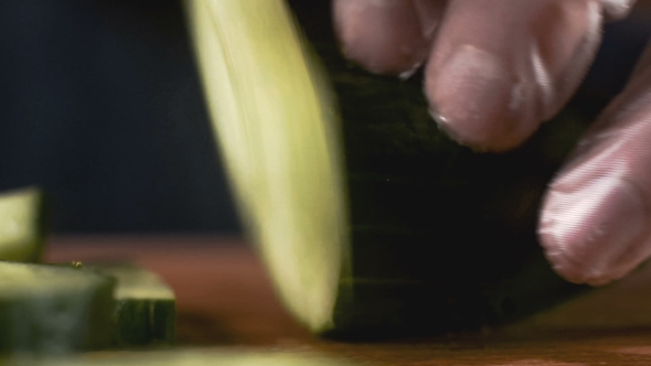 Chief Is Cutting a Cucumber with a Knife
