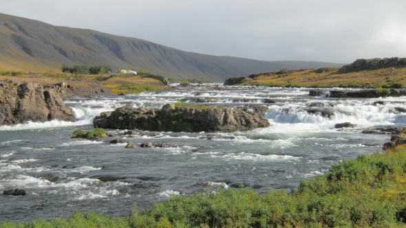 Small River Flowing From the Mountains in Icelandic Calm Landscape with Mountains