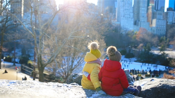 Adorable Little Girl Looking at the Famous Skating Rink in Central Park at New York City alt