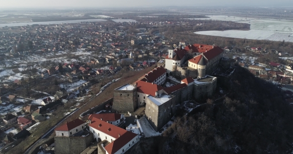 Beautiful Panoramic Aerial View To Palanok Castle at Sunset and the City of Mukachevo alt