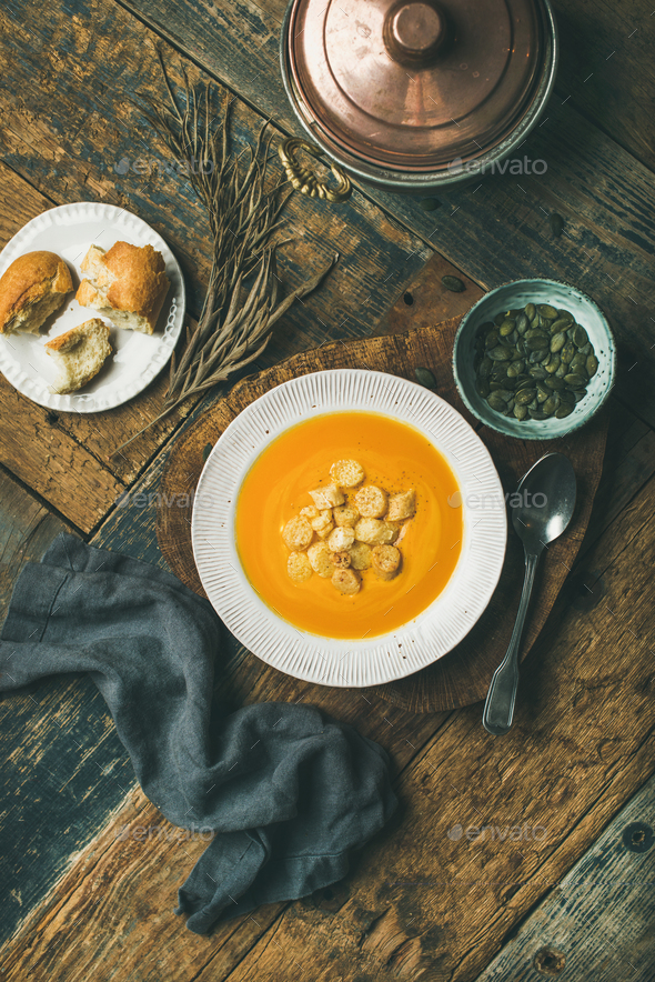 Warming pumpkin cream soup with croutons and seeds, vertical composition - Stock Photo - Images