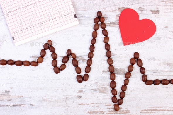 Cardiogram line made of roasted coffee grains and printout, medicine and healthcare concept Stock Photo by ratmaner