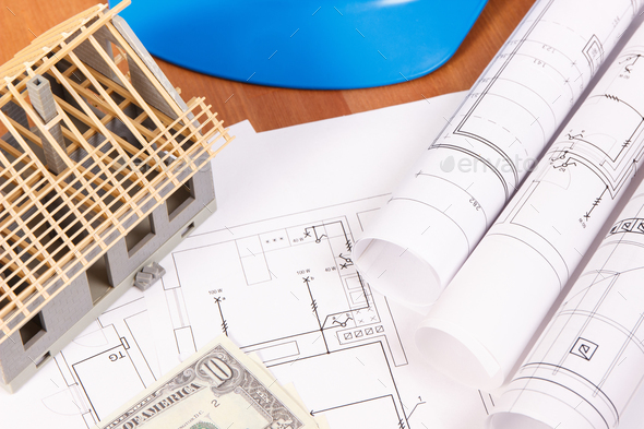 Electrical drawings, accessories for engineer jobs, house under construction and currencies dollar Stock Photo by ratmaner