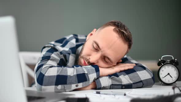 Overworked Male Manager Sleep on Desk After Hard Work Day alt
