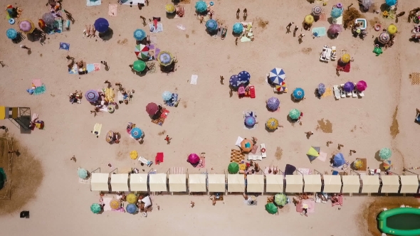 Aerial View of a Crowded Beach in a Sunny Hot DayYellow Sand and Umbrellas