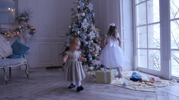 Children Near the Christmas Tree. Two Little Girls at Home, Christmas, New Year