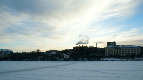 Overlooking the Winter City on the River. From the Chimney of the Plant Comes Thick