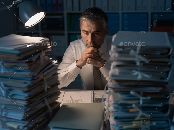 Business executive overloaded with work - Stock Photo - Images