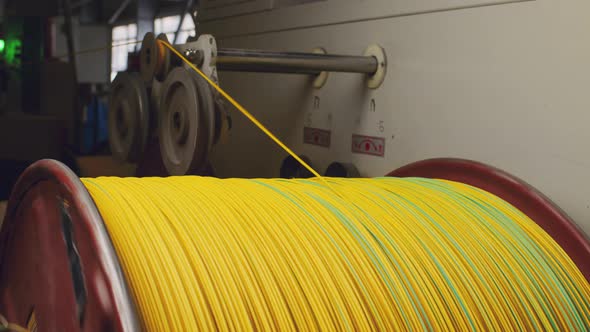 Spinning Reel with Yellow Cable in Cable Production Closeup