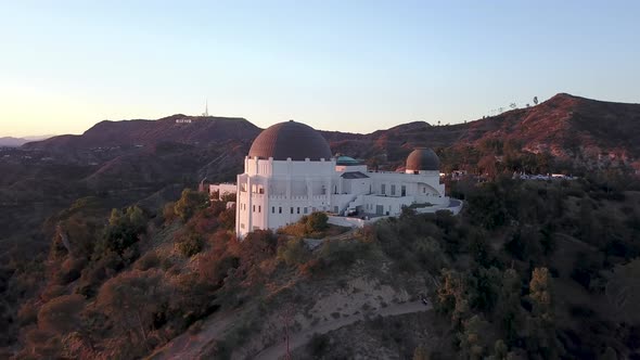 Flying away from the Griffith Observatory and the Hollywood sign on the hill in the distance in LA. alt