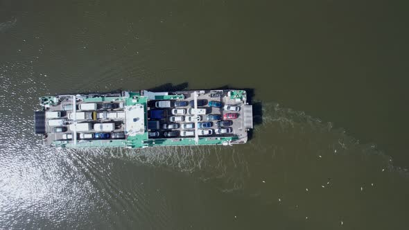 Aerial view of the ferry carrying cars to the other side of the river.