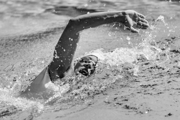 Female swimmer on training in the swimming pool Stock Photo by microgen