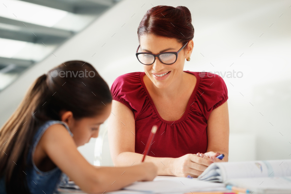 Education With Mom Helping Daughter Doing School Homework At Home - Stock Photo - Images