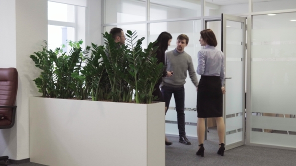 Businessman Invites a Team of Business People To Enter Meeting Room at Office