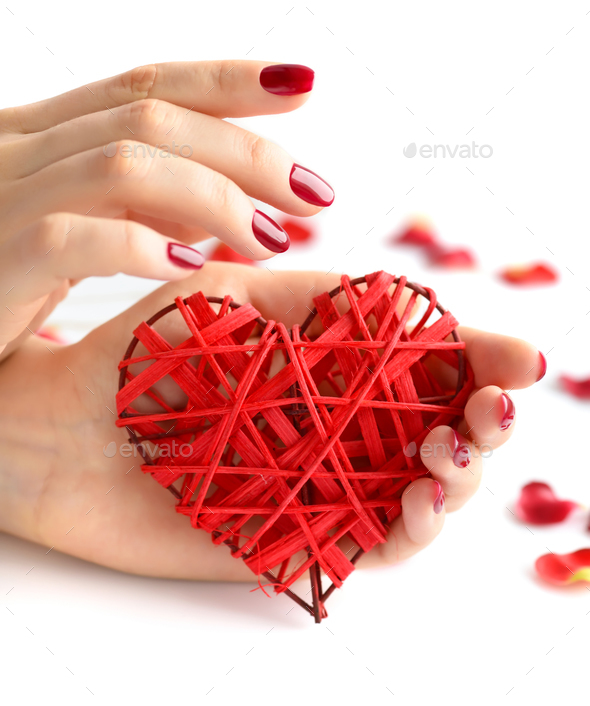 Wicker red heart in woman's hands on white background. Closeup h - Stock Photo - Images