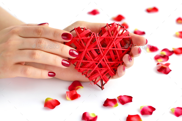 Wicker red heart in woman's hands on white background. Closeup h - Stock Photo - Images
