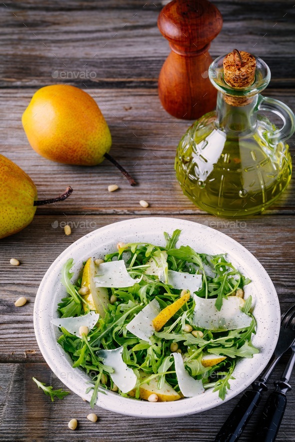 Download green salad bowl of arugula with pear, parmesan cheese and ...